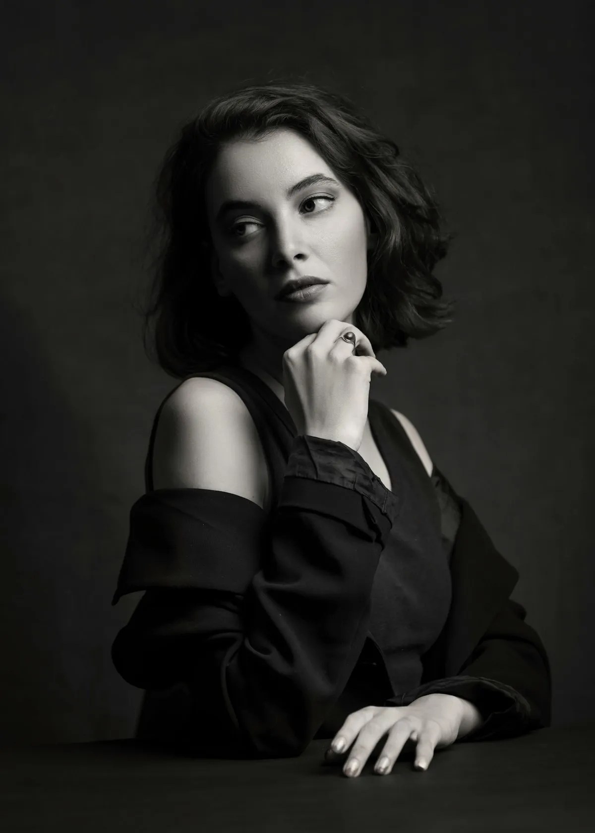 Creator in a dark studio, lit for an editorial portrait
