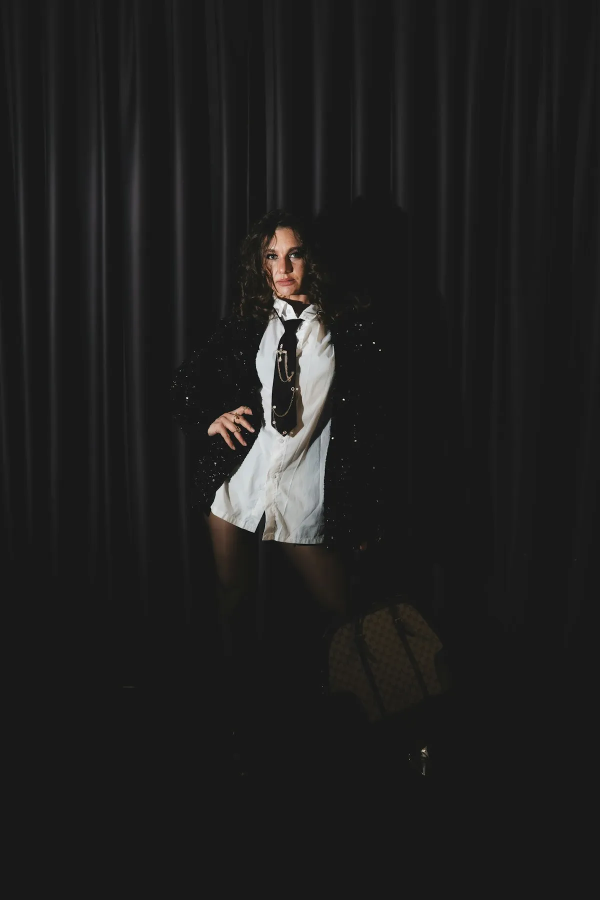 Talent in a sequined jacket under studio light
