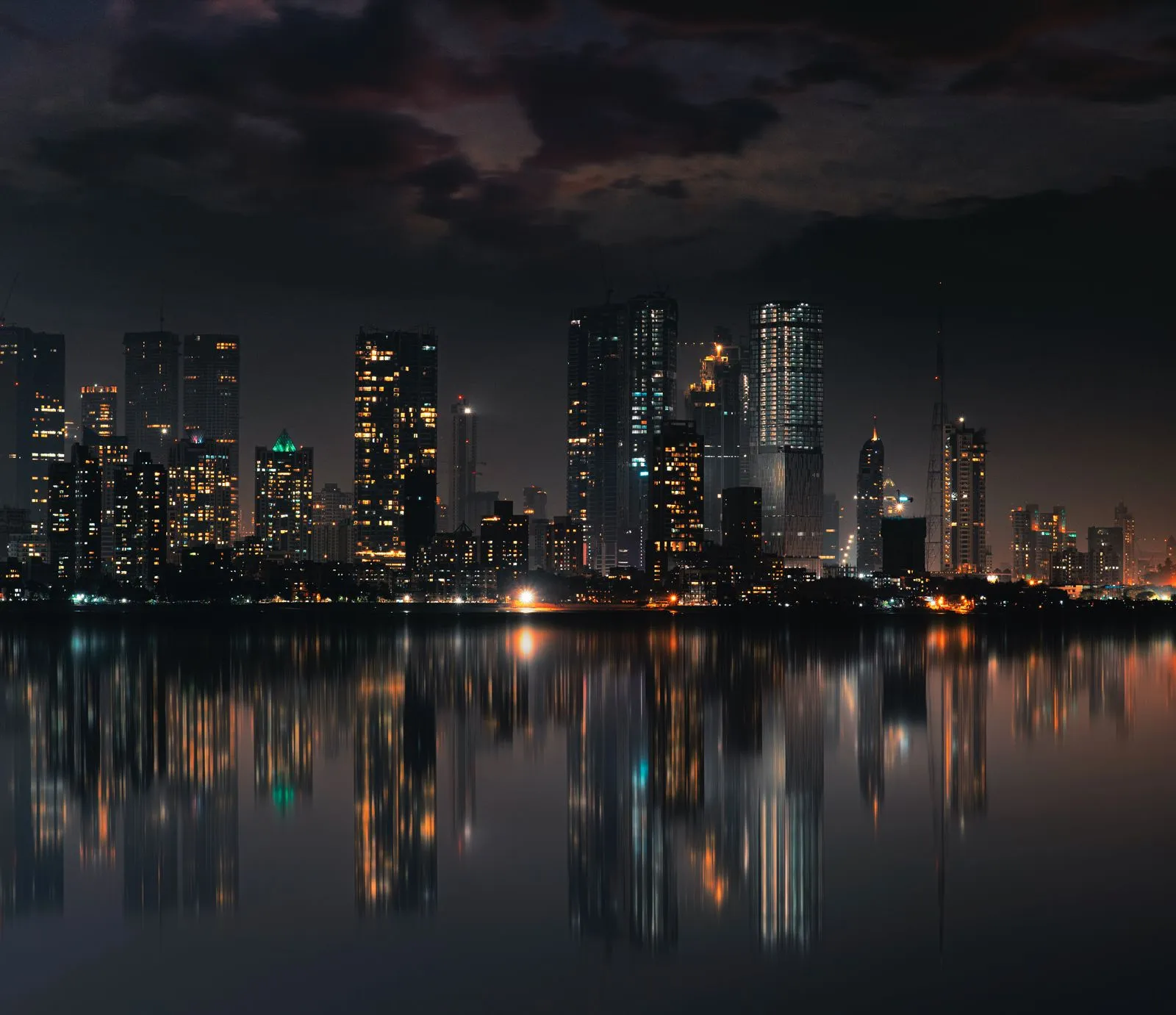 Mumbai skyline at night reflected on still water